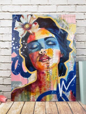 Colorful abstract painting of a woman's face on a brick wall background